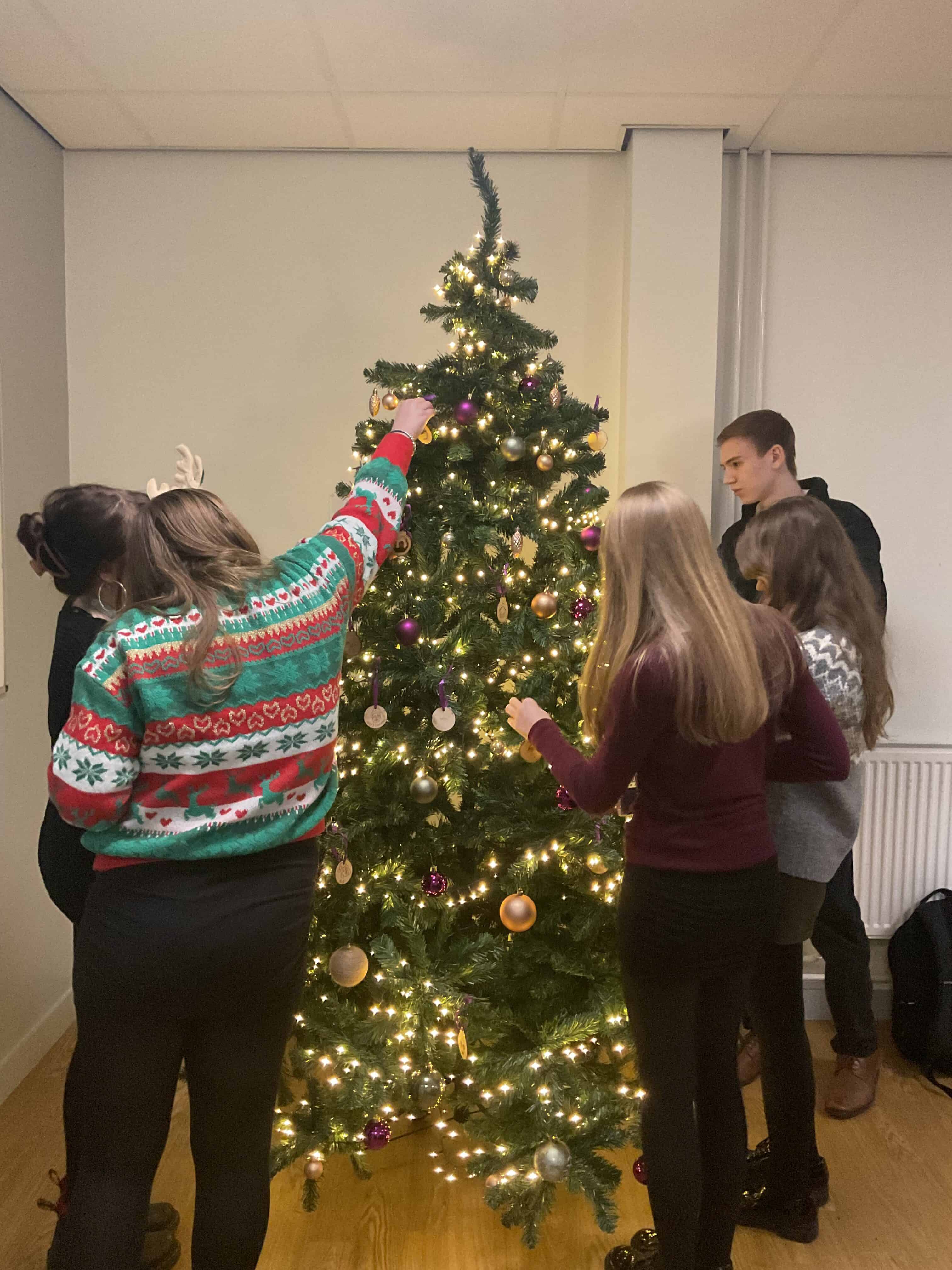 students decorating tree